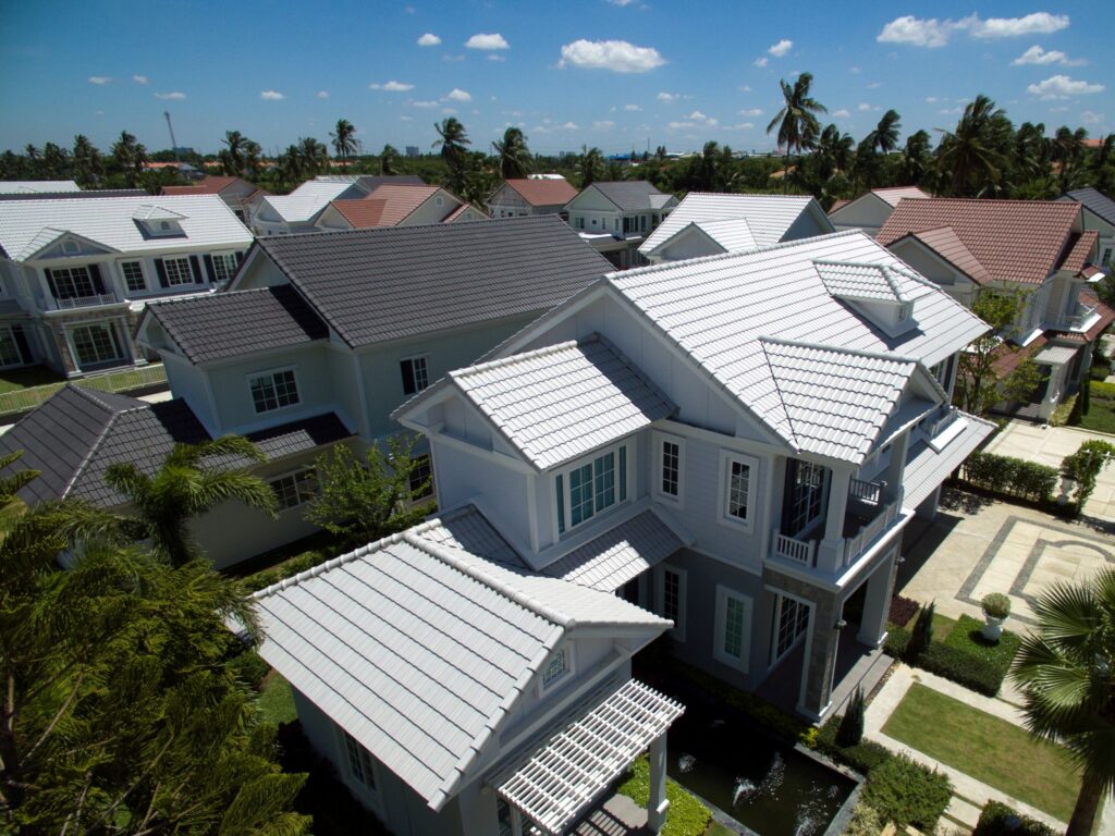 Residential homes with energy-efficient roofing in Simi Valley, showcasing various roof styles and materials under a clear blue sky.