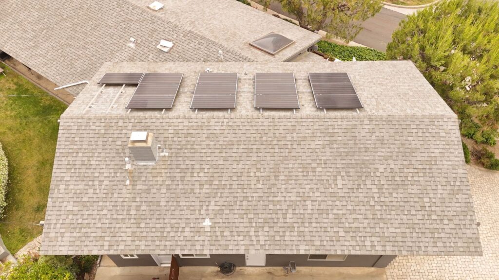 Roof with solar panels and shingles, showcasing a residential property in Simi Valley, relevant to HOA roofing guidelines and compliance.