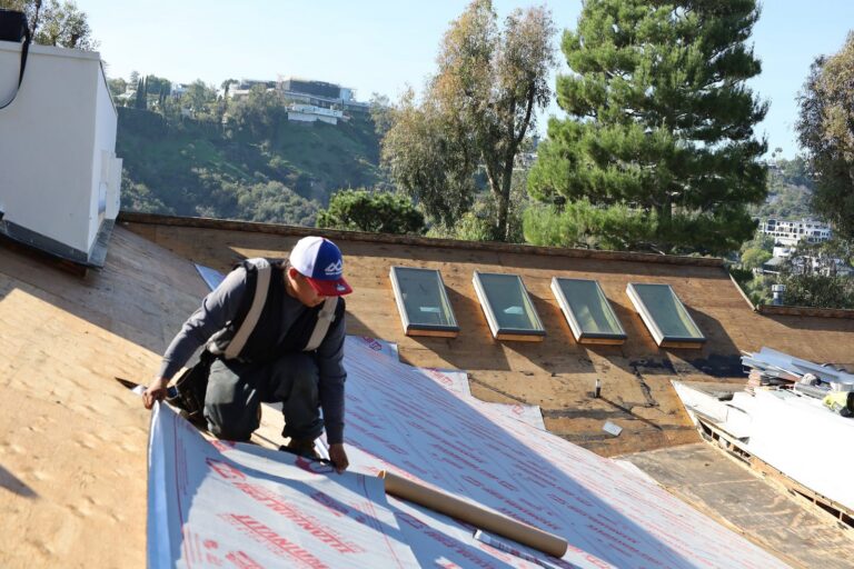 Infinity Roofers roofer installing synthetic underlayment on a Bel Air roof