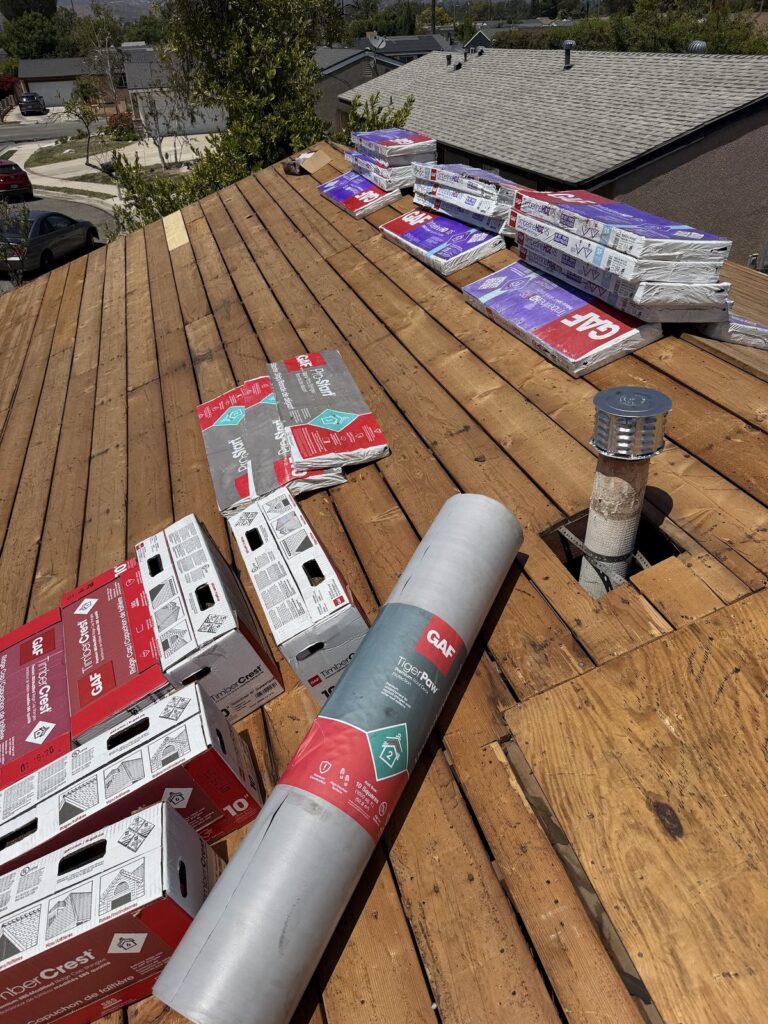 Roof deck with GAF underlayment and shingles staged during a Simi Valley roof replacement by Infinity Roofers