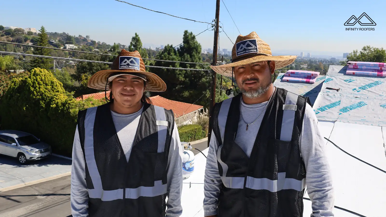 Two Infinity Roofers crew members on a roof job