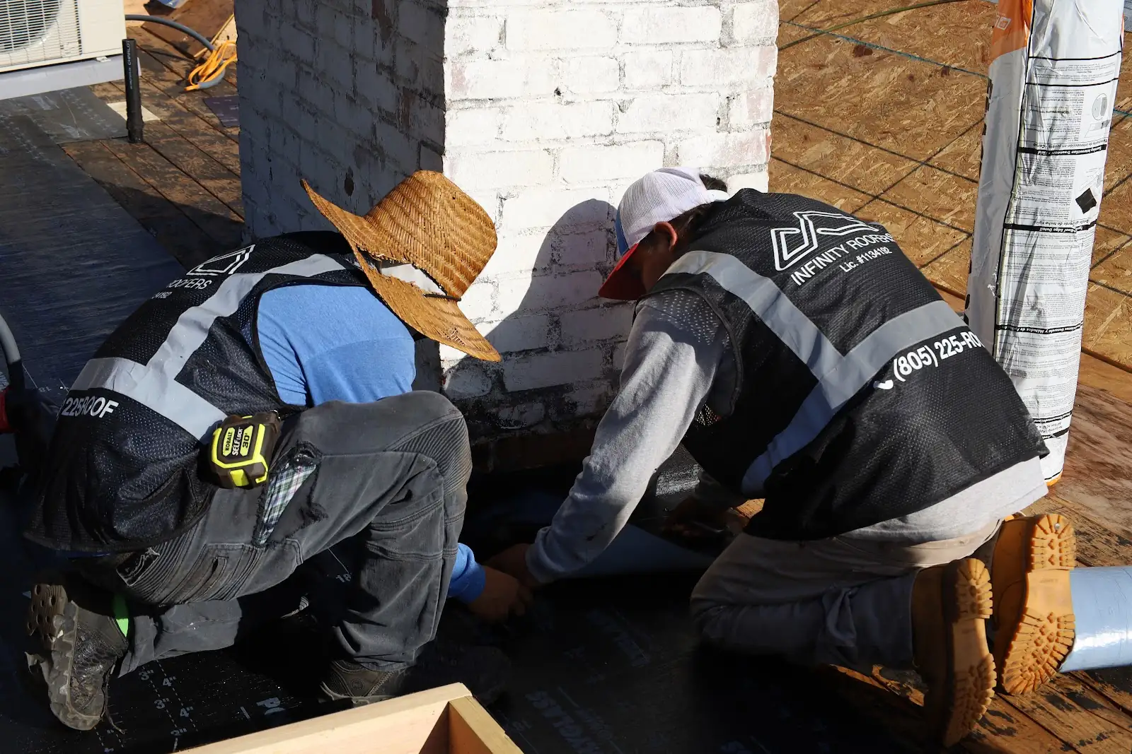 Infinity Roofers crew working together on a roof