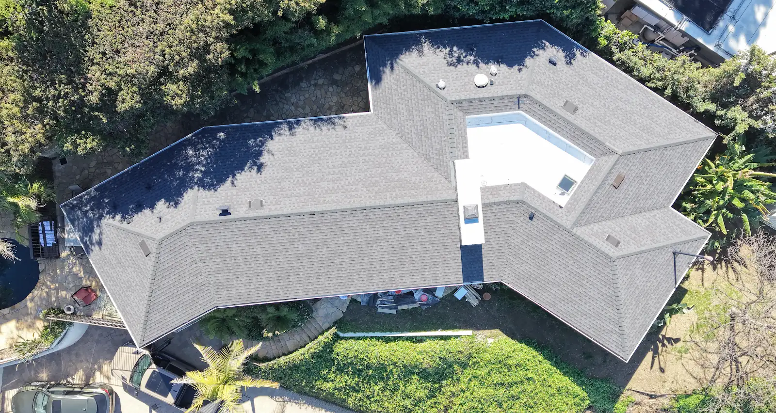 Finished shingle roof on a single-story home, seen from a drone