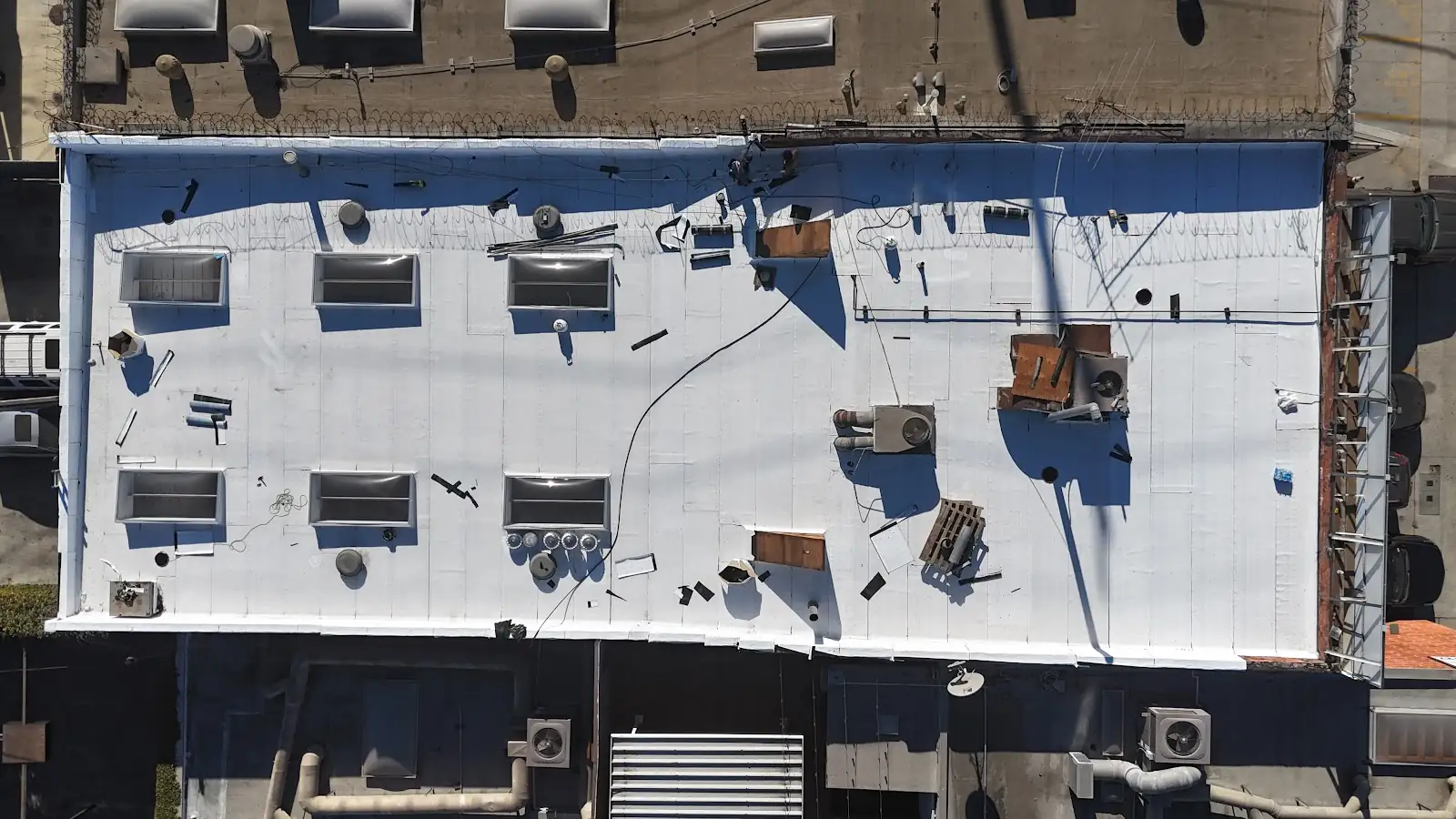 White membrane flat roof on a commercial building with skylights, from above