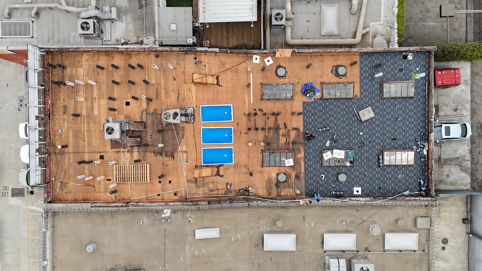 Commercial flat roof during tear-off by Infinity Roofers, seen from above